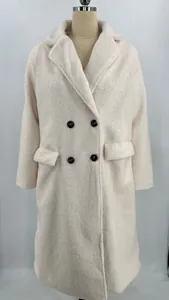 Detail of white fuzzy fleece coat with lapel collar and black buttons on a mannequin.