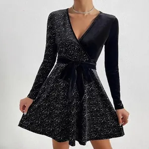 Elegant black velvet V-neck dress with long sleeves and shimmering sequin details