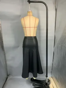 Back view of black high-waisted faux leather umbrella midi skirt on mannequin