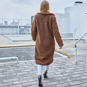Fashionable back view of a women's long brown fuzzy teddy coat with a warm lapel collar.