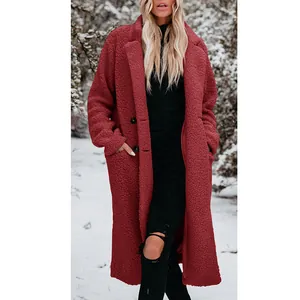 Close-up view of a long-sleeved warm burgundy plush teddy coat with lapels in snow