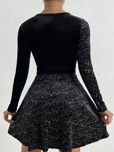 Elegant black velvet long sleeve dress featuring a sparkling sequin skirt seen from the back