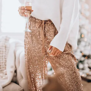 Close-up of sparkling rose gold sequin pants with drawstring waist for festive party