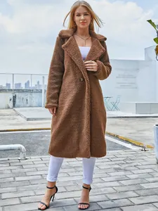 Stylish women's long brown teddy coat with lapel collar and fuzzy texture texture.