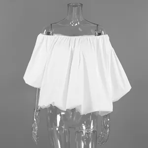 Detail of white cotton off-the-shoulder blouse on transparent mannequin display