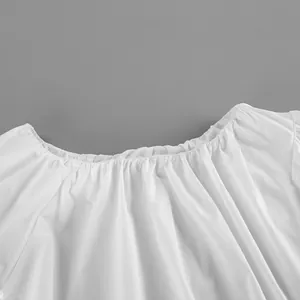 Detail shot of the elastic pleated neckline on a white cotton off-shoulder top