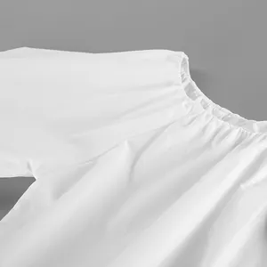 Close-up of the elastic gathered neckline and soft cotton fabric detail.