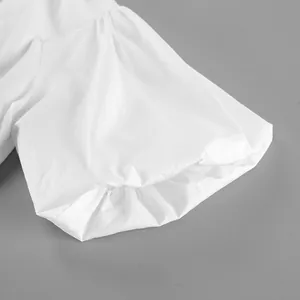 Macro view of white cotton puff sleeve with delicate pleated cuff detail for summer blouse
