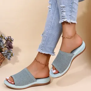 Stylish light blue knitted platform slide sandals for women shown with denim jeans