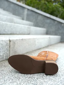 Close-up of non-slip rubber sole and chunky heel on embroidered western boot.