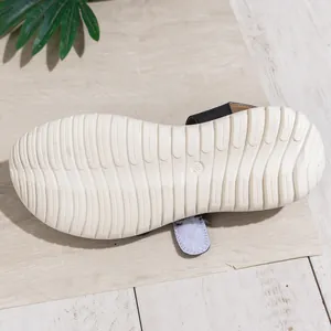 Close-up of the non-slip white sole of a casual wedge sandal with wave texture, size 38