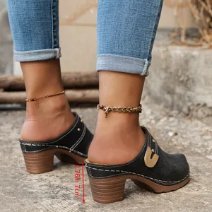 Detailed view of vintage carved black mule shoes featuring a 2.76in chunky heel.