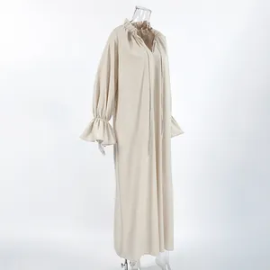 Detailed side view of a French style beige V-neck linen maxi dress with ruffled cuffs