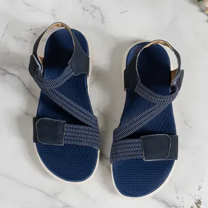 Overhead view of navy blue wedge sandals featuring elastic straps and Velcro fasteners.