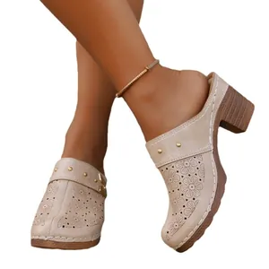 Elegant women's beige high-heeled mule clogs featuring floral cutouts and a block heel