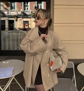 Stylish mid-length khaki trench coat for women in a street cafe setting