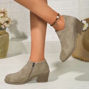 Side view of women's taupe suede ankle boots with chunky mid-heel and side zipper