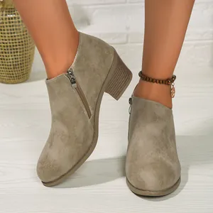 A detailed close-up of women's khaki suede ankle boots featuring a block heel and side zipper