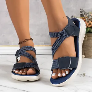 Navy blue women's wedge sandals with velcro straps and elastic cord stitching detail.