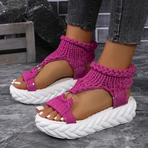 Detailed view of women's purple knitted platform sandals with chunky white soles