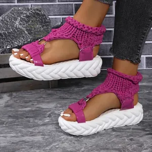 Detailed view of magenta knitted platform sandals with chunky white wavy sole