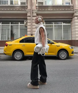 Elegant white faux fur sleeveless vest with high neck, ideal for winter urban streetwear style