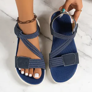 Top view of navy blue sporty sandals with velcro straps on marble background