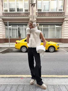 White faux mink fur sleeveless vest with high collar and zipper on street model