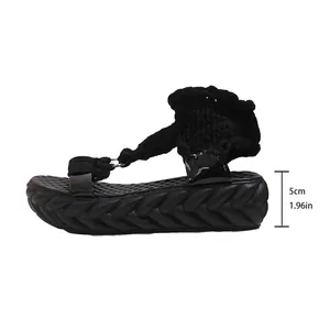 Side view of black platform sandals with 5cm thick sole and chunky knitted straps