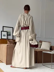 Back view of a beige French design linen maxi dress with pleated neck and side split