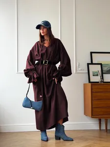 Full-length shot of a French-style burgundy linen maxi dress with lantern sleeves.