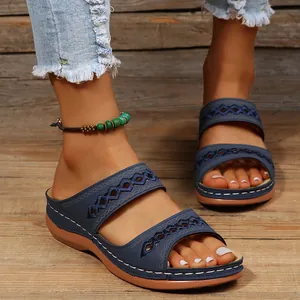 Gros plan de sandales compensées bleues vintage avec détails découpés sur bois