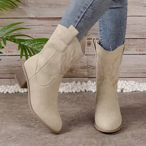 Detailed shot of beige embroidered V-cut Western cowboy boots with a stylish chunky heel.