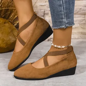 Vista dettagliata delle scarpe con zeppa da donna in pelle scamosciata marrone con cinturini