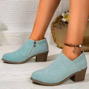 Detailed side view of light blue chunky heel ankle boots with side zipper design