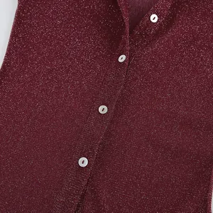 Detailed view of wine red shimmering shirt fabric featuring elegant white pearlescent buttons