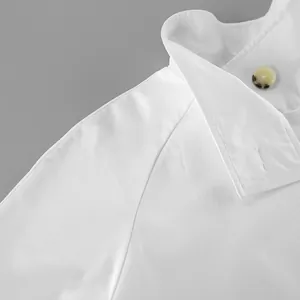 Detailed view of white women's trench coat featuring collar and raglan sleeve seam