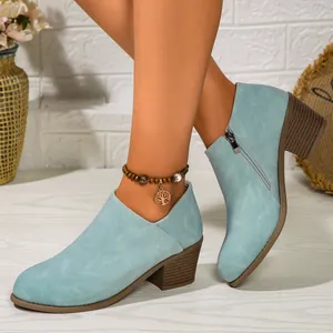 Light blue chunky heel ankle boots with side zipper and stacked mid heel detail