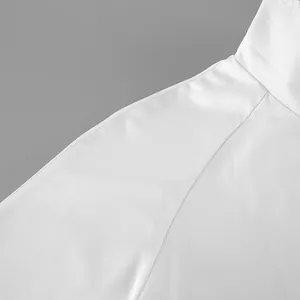 Close-up detail of a white trench coat showing collar stitching and premium fabric texture