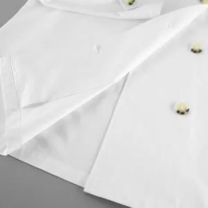 Close-up detail of white trench coat with tortoiseshell buttons and smooth inner lining