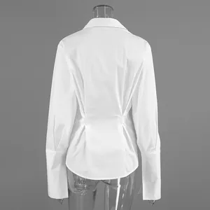 Detailed back view of a white cotton shirt featuring elegant waist pleats and extra long cuffs