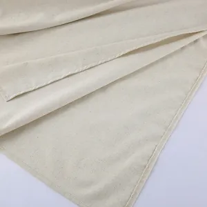 Close-up of beige linen fabric texture and seam detail for a French style dress.