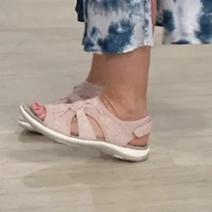 Detail side view of pink breathable flat sandals for women on feet
