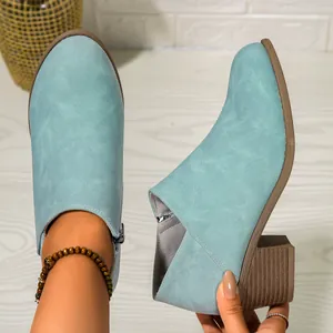 Side view of light blue chunky heel ankle boots with textured faux leather finish