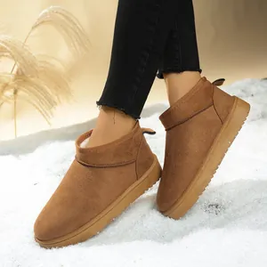 Close-up of brown suede snow boots with cozy faux fur lining for stylish winter warmth