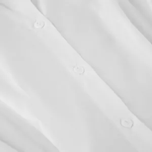 Detailed close-up of a white pure cotton shirt showing the texture and neat button placket