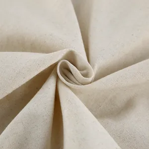 Close-up of natural beige linen fabric texture showing elegant drape and weave details