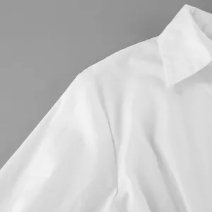 Detailed macro view of a crisp white cotton shirt collar and shoulder seam craftsmanship