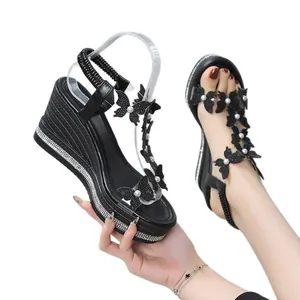 Elegant black women's wedge sandals with rhinestone butterfly decor and pearl accents