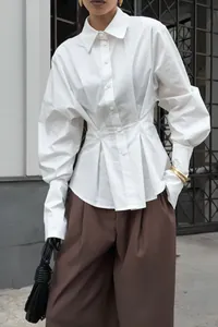 Elegant white cotton shirt featuring pleated waist and voluminous puff sleeves for women